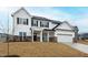 Beautiful two-story home with a covered entryway, a two car garage, and freshly laid lawn at 60 Rosewood Ln, Youngsville, NC 27596