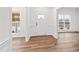 Bright foyer featuring light hardwood floors, white wainscoting, and natural light from two large windows at 60 Rosewood Ln, Youngsville, NC 27596