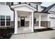 Charming front porch with elegant columns and a black front door, offering a welcoming entrance at 60 Rosewood Ln, Youngsville, NC 27596
