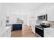 The kitchen features stainless steel appliances, wood floors, and a blue island at 60 Rosewood Ln, Youngsville, NC 27596