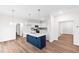 Open-concept kitchen features stainless steel appliances, island, and wood floors at 60 Rosewood Ln, Youngsville, NC 27596