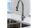 Close up of modern kitchen sink featuring stainless steel faucet and double basin at 60 Rosewood Ln, Youngsville, NC 27596