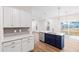 Kitchen area boasts white cabinets and stainless appliances, centered around a blue island at 60 Rosewood Ln, Youngsville, NC 27596