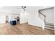 Open-concept living area with a kitchen island, modern lighting, and staircase at 60 Rosewood Ln, Youngsville, NC 27596