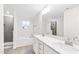 Main bathroom featuring a dual sink vanity, large mirror, soaking tub, and tiled shower at 60 Rosewood Ln, Youngsville, NC 27596