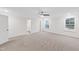 Bright main bedroom with neutral carpet, a ceiling fan, a bathroom, and large windows at 60 Rosewood Ln, Youngsville, NC 27596