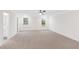 Spacious main bedroom with neutral carpet, a ceiling fan, and two large windows at 60 Rosewood Ln, Youngsville, NC 27596