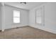 Bedroom features neutral carpet, two windows, and ample natural light at 605 Dunbar St, Durham, NC 27701