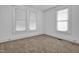 Bedroom with carpeted floors, two windows, and plenty of natural light at 605 Dunbar St, Durham, NC 27701