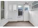 Enclosed porch with windows and a door leading to the outdoors at 605 Dunbar St, Durham, NC 27701