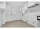Bright kitchen with white cabinets, space for appliances, and access to the backyard at 605 Dunbar St, Durham, NC 27701