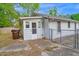 Rear exterior with a small porch, access to the backyard, and a fenced area at 605 Dunbar St, Durham, NC 27701