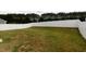 Large, fenced backyard with a mix of green and dry grass at 608 Crackling Ct, Zebulon, NC 27597