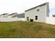 Backyard view with privacy fence, lawn and the rear of the home at 608 Crackling Ct, Zebulon, NC 27597