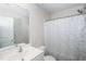 Bathroom featuring a shower with a white and green curtain, a toilet, and a sink with mirror at 608 Crackling Ct, Zebulon, NC 27597