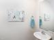 Stylish powder room with a modern sink, mirror, and tasteful decor at 608 Crackling Ct, Zebulon, NC 27597