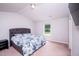 This bedroom has neutral walls and carpet and is furnished with a queen bed with a gray headboard at 608 Crackling Ct, Zebulon, NC 27597