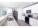 Modern kitchen featuring granite countertops, stainless steel appliances, and ample cabinet space at 608 Crackling Ct, Zebulon, NC 27597