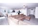 Spacious open-concept living area with modern flooring, a comfortable sofa, and a view of the kitchen at 608 Crackling Ct, Zebulon, NC 27597