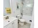 Bright bathroom featuring marble tile, a shower-tub combo, and a large vanity at 614 Henry St, Rocky Mount, NC 27803