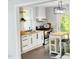 Updated kitchen features white cabinetry, butcher block countertops, modern backsplash, and stainless steel appliances at 614 Henry St, Rocky Mount, NC 27803