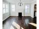 Spacious living room with hardwood floors, a decorative fireplace, and ample natural light at 614 Henry St, Rocky Mount, NC 27803
