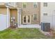 Cozy backyard patio area with a grass lawn, AC unit, and beige siding at 6323 Pesta Ct, Raleigh, NC 27612