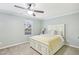 Cozy bedroom with a ceiling fan, large window, and a comfortable queen-sized bed at 6323 Pesta Ct, Raleigh, NC 27612