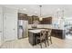 Modern kitchen with stainless steel appliances, dark cabinets, and a breakfast bar with seating at 6323 Pesta Ct, Raleigh, NC 27612