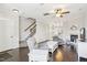 Open-concept living space featuring hardwood floors, fireplace, and staircase leading to the upper level at 6323 Pesta Ct, Raleigh, NC 27612