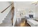 Open-concept living space featuring hardwood floors, fireplace, and staircase leading to the upper level at 6323 Pesta Ct, Raleigh, NC 27612
