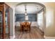 Traditional dining room with hardwood floors, wainscoting, and an archway entrance at 6901 Rex Rd, Holly Springs, NC 27540