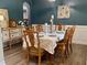 Elegant dining room featuring sophisticated decor, a table set for a meal, and warm, inviting lighting at 6901 Rex Rd, Holly Springs, NC 27540
