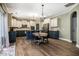 Bright eat-in kitchen featuring white cabinets, dark countertops, and stainless appliances at 6901 Rex Rd, Holly Springs, NC 27540