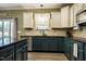 Bright kitchen with stainless steel appliances, dark granite counters, and ample cabinet space at 6901 Rex Rd, Holly Springs, NC 27540