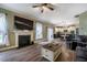 Spacious living room with wood floors, a fireplace, and access to the kitchen at 6901 Rex Rd, Holly Springs, NC 27540