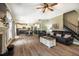 Spacious living room open to the kitchen with wood floors and a fireplace at 6901 Rex Rd, Holly Springs, NC 27540