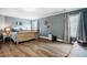 Large main bedroom with beautiful wall color, wood-look floors and natural light at 6901 Rex Rd, Holly Springs, NC 27540