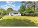 Expansive backyard view showing the home's back exterior, fencing, and detached garage or shed at 722 E Pine Ave, Wake Forest, NC 27587
