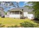 Exterior view showcasing a well-maintained backyard with a patio and screened porch at 722 E Pine Ave, Wake Forest, NC 27587