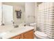 Well-lit bathroom featuring a vanity with ample counter space, toilet, and shower with curtain at 722 E Pine Ave, Wake Forest, NC 27587