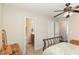 Serene bedroom with a ceiling fan, natural light, and convenient access to the en-suite bathroom at 722 E Pine Ave, Wake Forest, NC 27587