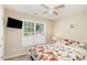 Inviting bedroom featuring a ceiling fan, window views, and a comfortable bed with floral patterned linens at 722 E Pine Ave, Wake Forest, NC 27587