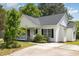 Charming home with a quaint front porch, lush landscaping, and a private driveway at 722 E Pine Ave, Wake Forest, NC 27587