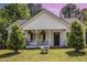Charming home with a cozy front porch, lush greenery, and well-maintained lawn at 722 E Pine Ave, Wake Forest, NC 27587
