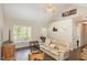 Inviting living room with hardwood floors, comfortable seating, and a bright window at 722 E Pine Ave, Wake Forest, NC 27587