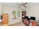 Bright office space with a window view, ceiling fan, and functional desk setup, perfect for productivity at 722 E Pine Ave, Wake Forest, NC 27587