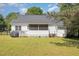 Backyard view of house featuring a screened-in porch, deck, grill, and well-maintained lawn at 722 E Pine Ave, Wake Forest, NC 27587