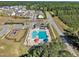 Overhead view of community pool and recreation area, surrounded by lush trees and well-maintained neighborhood at 743 Hadstock Path Path, Zebulon, NC 27597