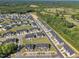 An aerial shot displays a neighborhood of modern houses, thoughtfully designed with ample green space at 743 Hadstock Path Path, Zebulon, NC 27597